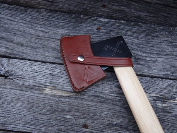 A wooden handle with an ax on top of it.