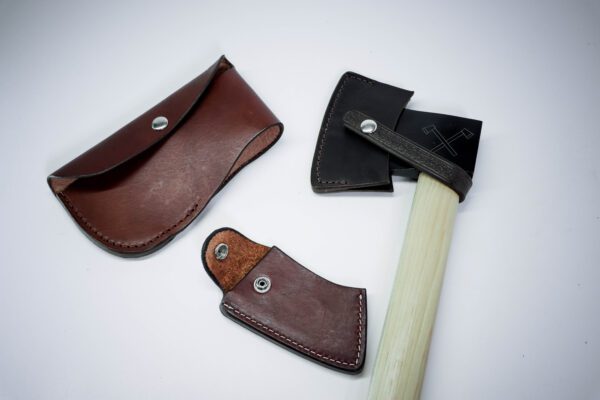 A pair of leather axe sheath and a wooden handle.