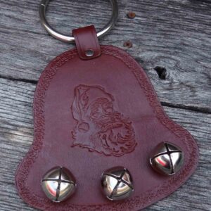 A leather key chain with bells on it.