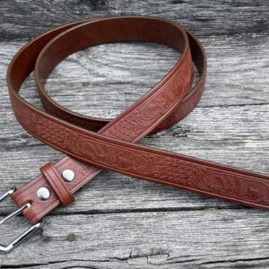 A brown leather belt sitting on top of a wooden table.