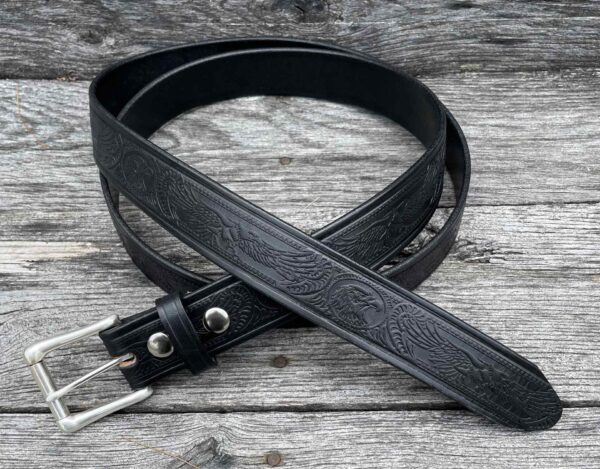 A black belt sitting on top of a wooden table.