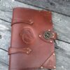 A brown leather book with a horse on the cover.