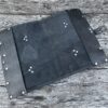 A black leather case sitting on top of a wooden table.