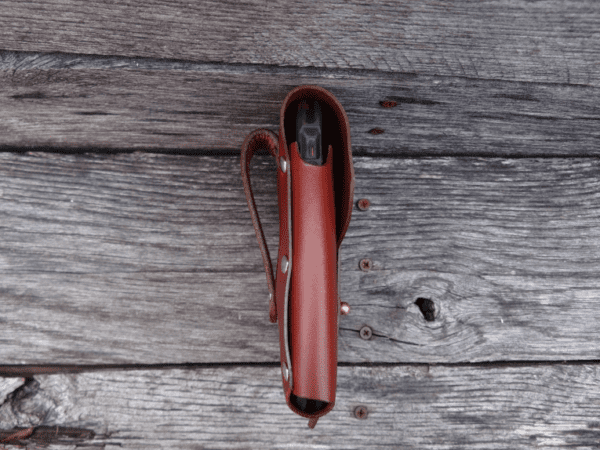 A red leather case is open on the ground.