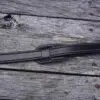 A black strap on the side of a wooden deck.