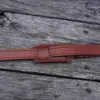 A red belt is laying on the ground