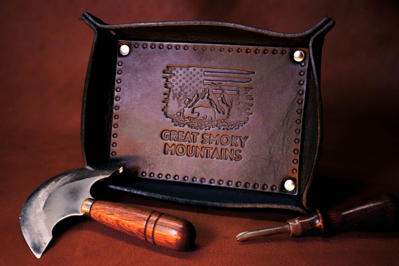 A leather tray with an eagle and flag on it.