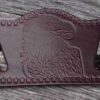 A brown leather wallet with an eagle on it.