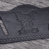 A black leather belt with an eagle on it.