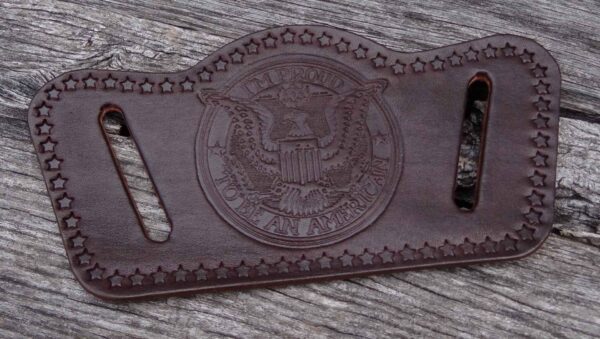 A brown leather belt with an eagle on it.