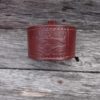 A close up of the top part of a leather bracelet