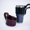 A cup and holder are sitting on the table.