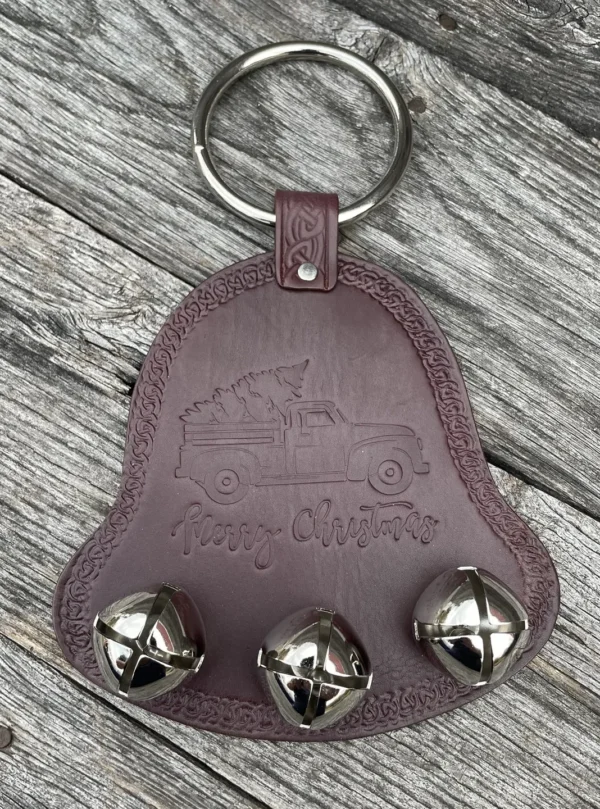 A brown leather key chain with three bells.