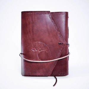 A brown leather book with a tree on the cover.