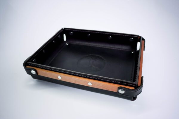 A black tray with wooden sides and metal handles.