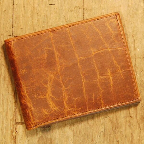 A brown leather wallet sitting on top of a wooden table.