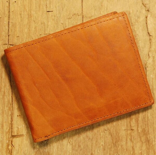 A brown wallet sitting on top of a wooden table.