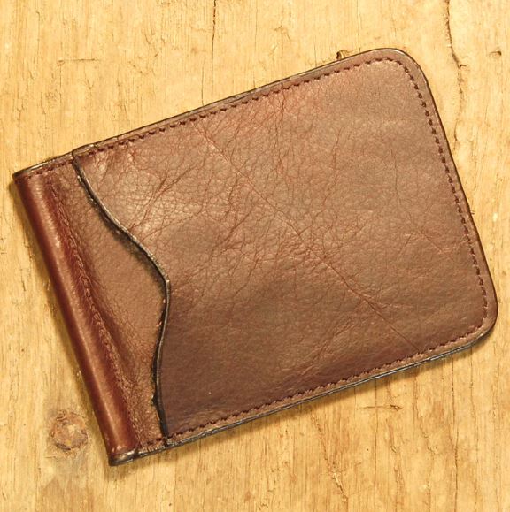 A brown wallet sitting on top of a wooden table.